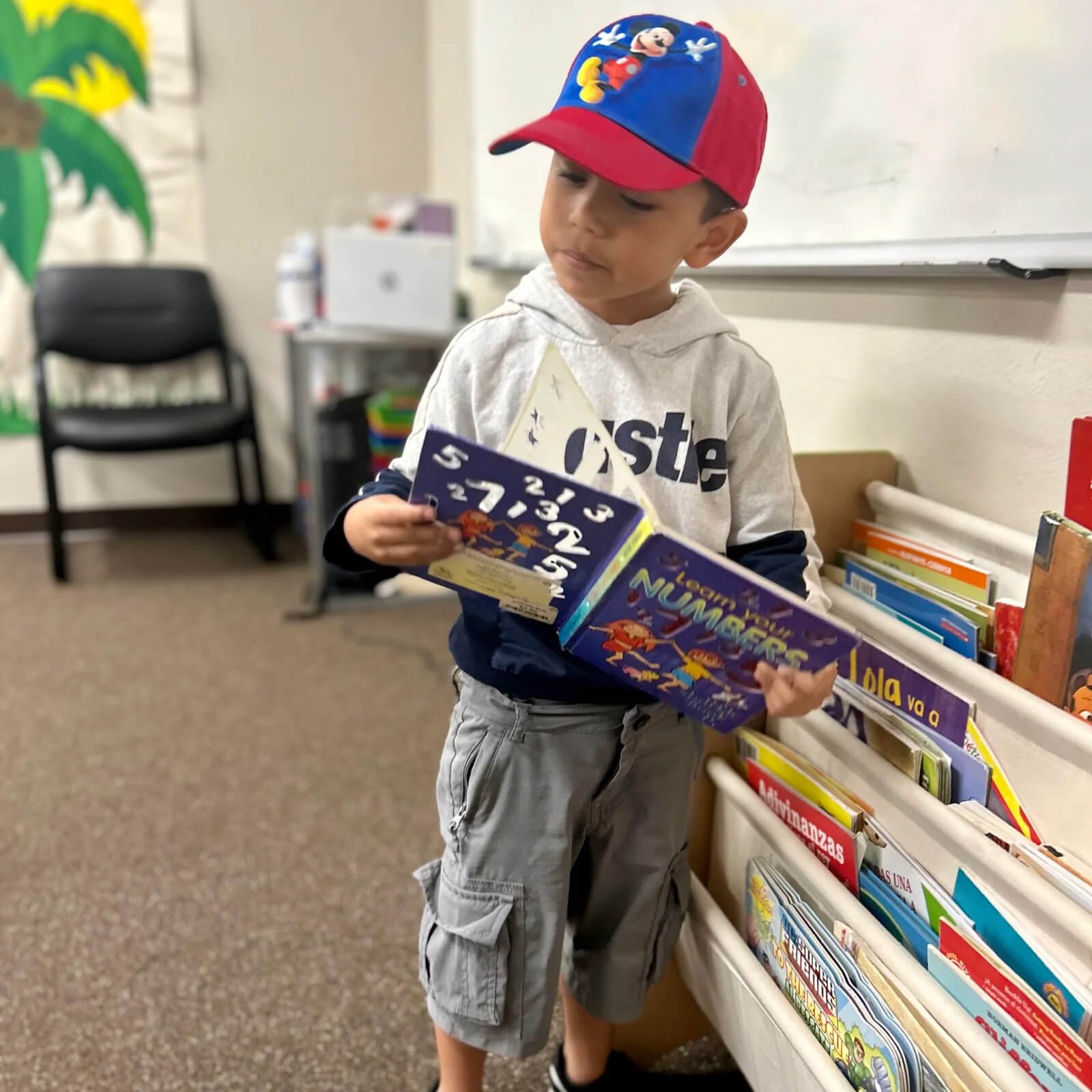 kid-in-baseball-cap-reading-numbers